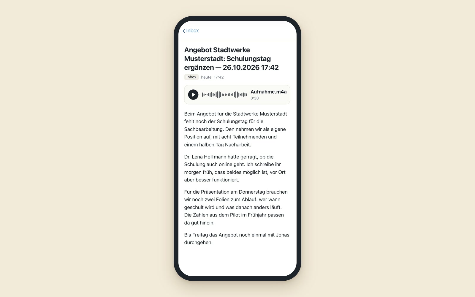 Finished note on a phone in the archive’s inbox notebook: the headline “Quote for Stadtwerke Musterstadt: add a training day” with date and time, below it the original recording as an attachment and the processed text in four paragraphs (fictional example).